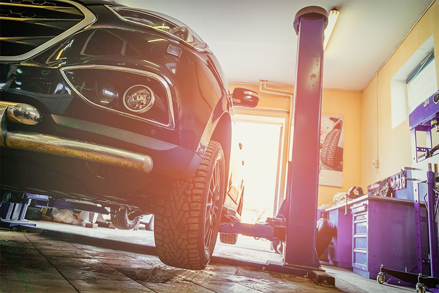 Specialized Business Insurance - View of a Car Being Repaired in a Auto Repair Shop with a Vintage Filter